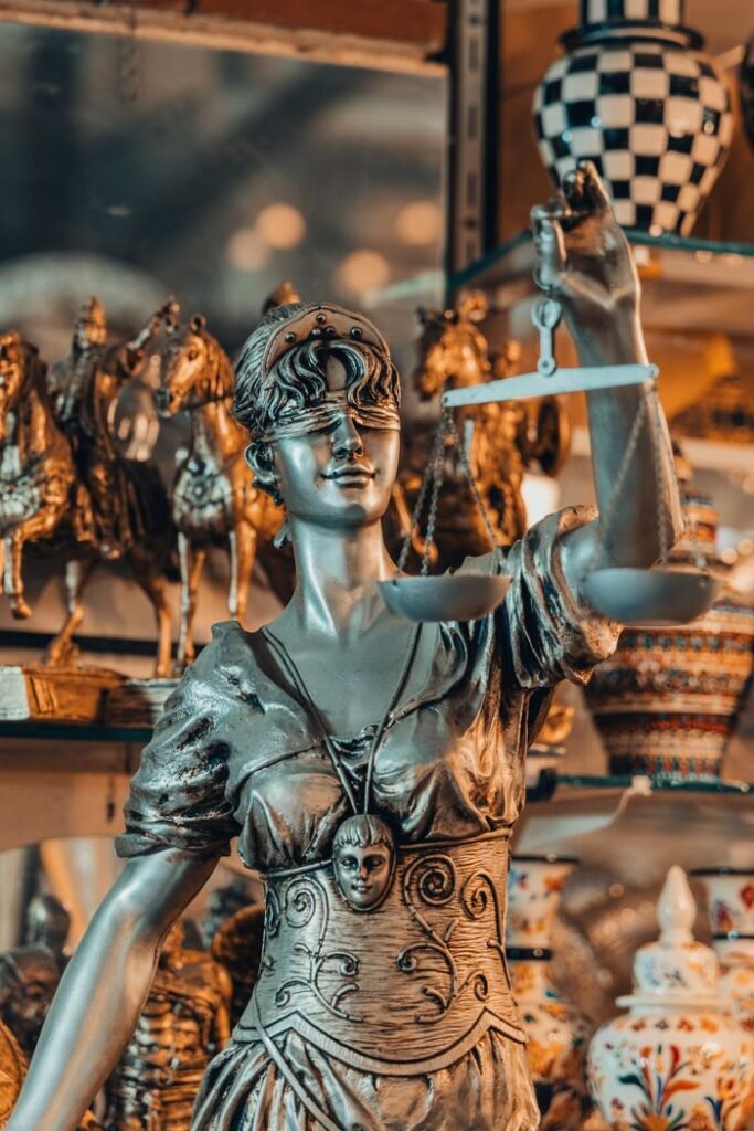 Crafting Captivating Headlines: Your awesome post title goes here Bronze Lady Justice statue holding scales in antique shop. Elegant and symbolic representation of justice, law, and fairness.